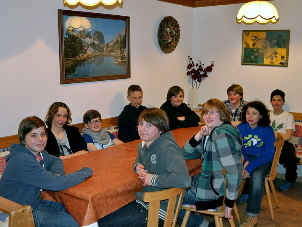 Gruppe sitzt an einem Tisch im Aufenthaltsraum.